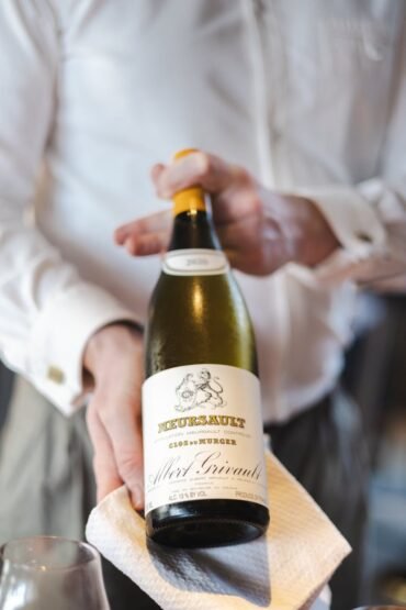 sommelier presenting fine white wine