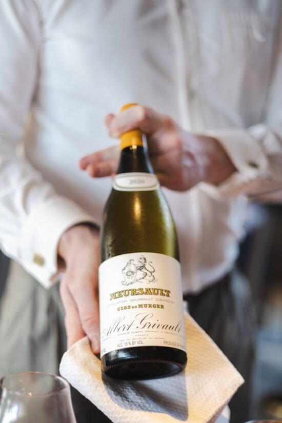 sommelier presenting fine white wine