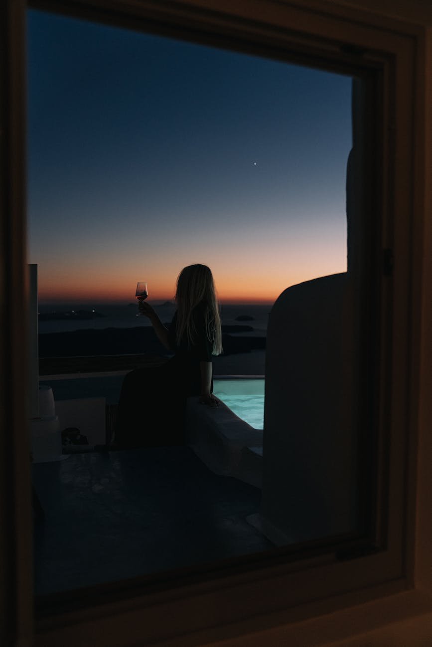 woman drinking wine at dusk