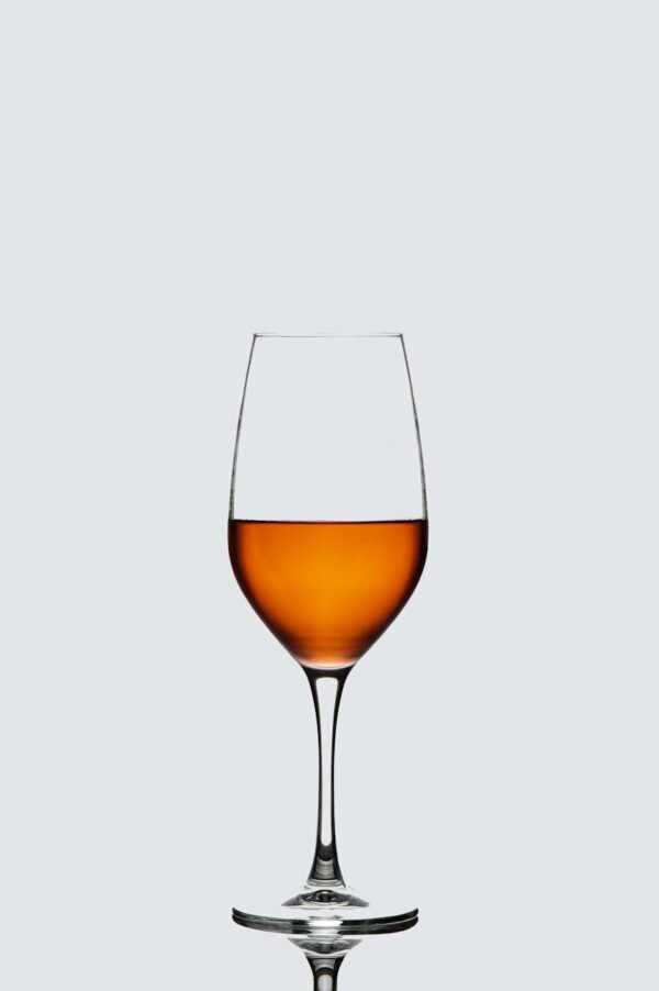 a wine glass with a liquid inside