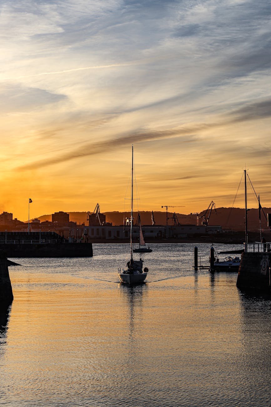 sailboat on sea coast at sunset