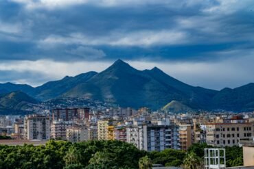 scenic view of palermo city with mountain backdrop