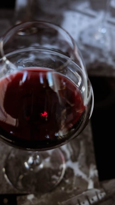 selective focus photo of a wine glass with red wine